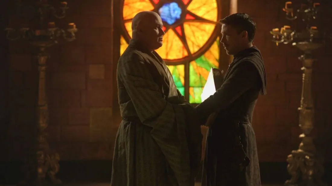 Varys and Littlefinger watching each other with courtly suspicion.